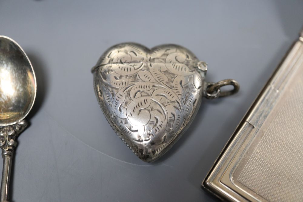 A silver compact, silver heart vesta, Russian silver-mounted Last Supper plaque, spoons and sundries